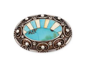 1319 A Southwest sterling silver belt buckle Mid/late 20th century In a Zuni style, a chunky buckle featuring a central turquoise and bone inlay sunburst motif edged with applied curvilinear silver wire and ball accents Unmarked 2 3/4 x 4 in.; belt bar 2 in. 135.8 grams gross Estimate: $200 - $300