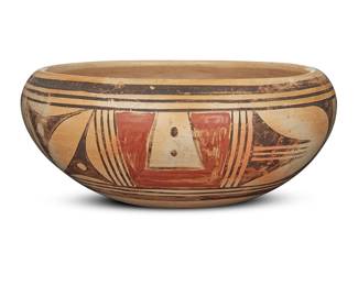 1030 A Hopi polychrome yellowware pottery low bowl Mid-20th century The exterior with red and black band of geometric motifs on cream slip ground Unmarked Height 4 in., diameter 9 3/4 in. Estimate: $200 - $300