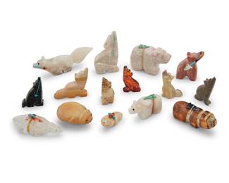 1424 Fifteen Zuni carved mammalian fetishes Mid/late 20th century, mostly Zuni Pueblo From artists including Melissa Quam, Emery Eriacho, and Kenny Chavez, comprising mostly bears, wolves and coyotes, most carved from various hardstones, as well as jet, tagua nut, amber, and antler, six with inset turquoise, coral, or silver heartlines, and five mounted with offerings Each unsigned, three with labels indicating artist 15 pieces Largest height 1 1/2 in., width 3 1/2 in., depth 5/8 in.; smallest height 3/4 in., width 1 5/8 in., depth 5/8 in. Estimate: $200 - $400