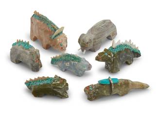 1420 Leonard "Old Man" Halate (1914- 2001, Zuni) Seven carved stone animal and dinosaur fetishes, mid/late 20th century Comprising five carved hardstone dinosaur and lizard-style figures, each with inlaid applied shell zigzag spikes and horns, and with scattered turquoise chips to backs, as well as a carved stone badger and a elephant, each with stone inlay eyes and one mounted with an offering Unsigned, two with attached label 10 pieces Largest height 2 1/2 in., width 3 3/4 in., depth 1 1/4 in.; smallest height 1 1/2 in., width 3 in., depth 7/8 in. Estimate: $200 - $400