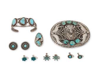 1408 A group of Southwest-style sterling silver and turquoise jewelry Mid/late 20th century Buckle with indistinct marks; cuff etched: MJU; earring posts stamped: Sterling Six works comprising a large sterling oval buckle with set turquoise, silver wire and feather motif overlay, and a central buffalo head, and a large set turquoise ring, as well as a three-wire cuff with three set turquoise plaques, and four pairs of silver and turquoise earrings including petit point Buckle with indistinct marks; cuff etched: MJU; earring posts stamped: Sterling 11 pieces Buckle 3 1/2 x 4 in.; cuff 6 1/2 in. total inner C x 1 in., including a 1 1/4 in. gap; earrings 1/2 to 7/8 in.; ring size 9 3/4 217.5 grams gross Estimate: $600 - $800