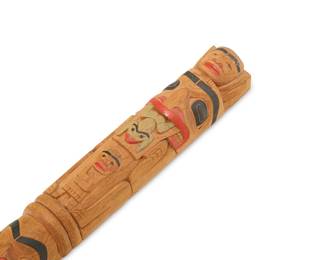 1151 Mike Epp (b. 1962, Gitlaan/Coast Tsimshian) A polychrome carved cedar speaker's staff, late 20th century Depicting eleven figures including a bear, raven, and frog, a shaman, and a human in transfiguration, with two copper ring accents Incised: ME; with lengthy inked inscription, possibly in the artist's hand Length 58 in., diameter 2 1/4 in. Estimate: $400 - $600