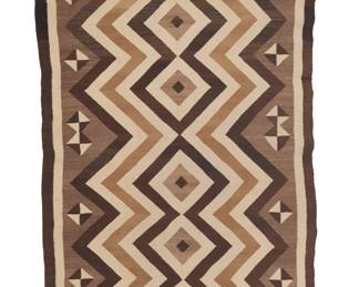 1267 A fine Diné (Navajo) Two Grey Hills rug First half 20th century Finely woven in brown, cream, tan, and mottled brown wool with a central column of stacked diamonds with concentric zigzags and floating two-tone diamonds to sides 4 ft 1 in. x 2 ft. 8 in. approximately Estimate: $600 - $800