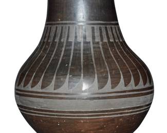 1071 Carmelita Dunlap (1925-1999, San Ildefonso Pueblo) A blackware pottery vessel With black-on-black slip-painted band of feather motifs to shoulder Incised to underside: Carmelita Dunlap / San Ildefonso Pueblo Height 8 in., diameter 7 in. Estimate: $200 - $400