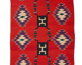 1217 A Diné (Navajo) Germantown textile Late 19th century Featuring a central column of four black storm pattern motifs flanked on either side by a column of five sawtooth diamonds, all on a red ground, woven in red, cream, black, green and purple wool yarn, with red yarn fringing to each corner 6 ft. 1 1/2 in. x 3 ft. 2 1/2 in. approximately Estimate: $1,000 - $2,000