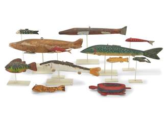 1239 Twelve Folk Art polychrome carved wood fish and amphibian models 20th century A large group of polychrome painted wood fish of various species as well as a turtle and two swimming frogs, each in various colors and each with painted metal fins or other accents, ten mounted to custom painted steel stands 12 pieces Largest height 3 1/2 in., width 18 in., depth 7 1/4 in.; smallest height 3/4 in., width 4 in., depth 2 in.; stand heights 9 to 3 1/2 in. Estimate: $400 - $600