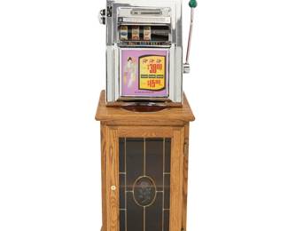 1304 A Mills 'Primadonna' slot machine 1950s The ten-cent machine with three reels, housed in an enameled and chromed metal case, electrified, raised on a glazed wood locking cabinet with single shelf and brass paw feet Height of machine 28 3/4 in., width 19 in., depth 15 in.; height of cabinet 34 in., width 19 1/2 in., depth 19 1/2 in. Estimate: $500 - $800