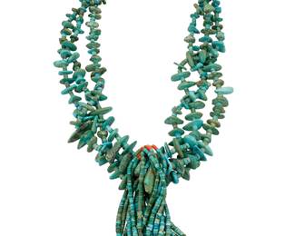 1322 A Pueblo multi-strand turquoise necklace with jaclas Early/mid-20th century A chunky three-strand necklace with graduated tab turquoise with turquoise spacers, suspending five pairs of turquoise, coral, and shell jaclas, the strands with a traditional wrapped neck cord Unmarked 30 in. x 6 in. approximately 590.1 grams gross Estimate: $700 - $900