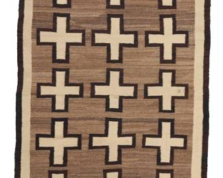 1231 A Diné (Navajo) regional rug Mid-20th century Woven in cream, brown, and mottled grey/brown wool with three columns of floating crosses within a double border 6 ft. 2 in. x 3 ft. 9 in. approximately Estimate: $700 - $900
