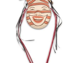 1079 Kathleen Wall (b. 1973, Jemez Pueblo) A polychrome Koshare pottery wall mask with ribbon and removable corn husk accents Signed in slip verso: Kathleen Wall Height (excluding corn husks) 9 3/4 in., width 7 3/4 in., depth 4 1/4 in. Estimate: $200 - $400