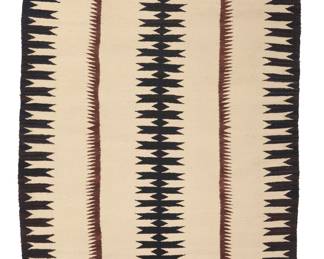 1275 A Diné (Navajo) regional rug Mid-20th century Woven in cream, brown, and black wool with a central narrow serrated column and similar complex serrated border to the long sides 5 ft. 8 in. x 3 ft. 2 in. approximately Estimate: $500 - $700