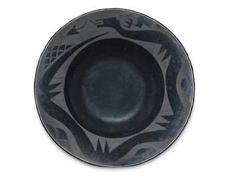 1066 Maria Martinez (1887-1980, San Ildefonso Pueblo) A blackware pottery bowl, circa 1920s With black on black Avanyu painted to the wide rim, and raincloud motifs Incised with signature to underside: Marie Height 3 1/8 in., diameter 12 1/4 in. Estimate: $1,000 - $1,500