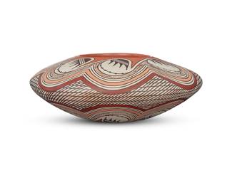 1041 Helen Naha (Feather Woman) (1922-1993, Hopi-Tewa) A polychrome pottery low jar With wide shoulder, decorated with tan, brown, ochre, and black banded migration motif to shoulder and lower body, on white slip ground Signed in slip to underside with artist's feather device Height 3 5/8 in., diameter 10 1/2 in. Estimate: $1,000 - $1,500