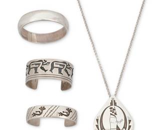 1393 Four Southwest sterling silver & pictorial overlay jewelry items Late 20th century Comprising a large teardrop pendant necklace with delicate overlay katsina dancer profile motif and fine geometric accents, as well as a narrow storyteller cuff with Kokopelli motifs and stampwork banding by David Reeves (b. 1948-n.d., Diné [Navajo]), a wide Hopi-style cuff with multiple heartline bear motifs, and a chunky sterling silver bangle by Verna Tahe (20th century, Diné [Navajo]) Three variously marked for artist: D. Reeves / TAHE / [impressed triangle]; three marked for sterling 4 pieces Necklace 21 1/2 x 3 in.; cuffs 7 1/8 in. total inner C x 1 1/4 in. and 7 1/8 in total inner C x 3/4 in., each including a 1 3/8 in. gap; bangle 8 1/8 in. inner C x 3/4 in. 244.7 grams gross Estimate: $200 - $400