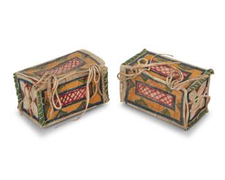 1115 A small pair of Plains painted parfleche boxes Second half 20th century Each rectangular polychrome painted hide sinew-sewn box or doll trunk featuring various geometric and stylized floral motifs, with hide lacings and handles, and green cloth edging to sides 2 pieces Each height 2 1/4 in., width 3 3/4 in., depth 2 1/4 in. approximately Estimate: $200 - $400