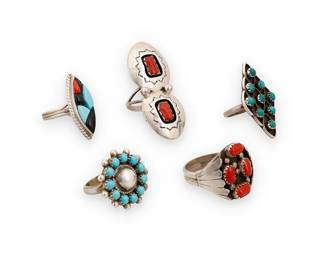 1382 Five Southwest sterling silver and set stone rings Mid/late 20th century A group of sterling silver rings in various set stone styles including a shadow set coral ring by Valerie Goodluck (20th century, Diné [Navajo]), and a multistone inlay ring by Richard & Geneva Terrazas (each 20th century, Mexican & Zuni), as well as three further cluster set rings, two with turquoise-colored stones and one with coral Two stamped for artist; two stamped for sterling 5 pieces Ring sizes 11 to 4 1/2 27.4 grams gross Estimate: $400 - $600