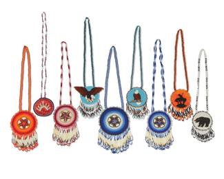 1124 Nine Anishinaabe (Ojibwe) polychrome pictorial beaded pendant necklaces Attributed to Ida Beaulieu (d. 2021, Anishinaabe [Ojibwe]) Comprising four floral bead and porcupine quill pendants, in blues, reds, and oranges, each with an ombré shaded medallion with tonal fringe bead and quill dangles, together with two eagle motif medallion necklaces, a bear motif necklace, one with an 'End of the Trail' motif medallion with a mounted warrior silhouette, and a smaller 'Sunset' medallion worked in red and white quill with blue bead edging 9 pieces Largest 23 x 8 in.; smallest 30 x 3 1/8 in. Estimate: $400 - $600