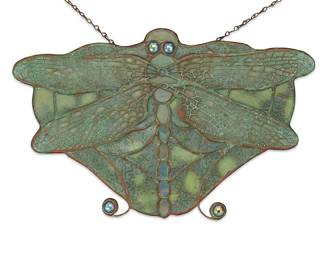 1242 A Tiffany Studios Favrile glass dragonfly lamp screen Early 20th century The wings with metal overlay filigree Unmarked Height 6 5/8 in., width 10 1/8 in., depth 1/2 in. Estimate: $1,000 - $2,000
