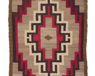 1264 A Diné (Navajo) regional rug Mid-20th century Woven in mottled brown, dark brown, tan, cream, and red wool featuring a central hooked diamond and narrow band border 4 x 3 ft. approximately Estimate: $400 - $600
