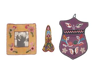 1125 Three Native American beaded items Late 19th/early 20th century Comprising a shield-shaped Tlingit pictorial polychrome beaded purple felt wall pouch with floral motifs and a butterfly, a Plateau floral beaded scissors case top, and a Northeast beaded picture frame with floral motifs and a printed calico backing 3 pieces Pouch 11 3/4 x 8 in.; scissors case top 7 1/2 x 3 1.2 in.; frame 8 1/2 x 8 1/4 in. Estimate: $200 - $400