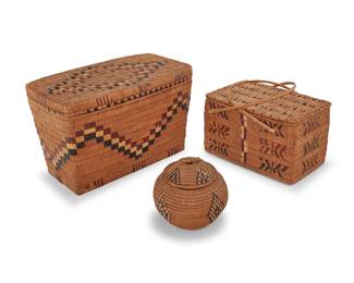 1154 Three Salish polychrome lidded baskets First half 20th century; Pacific Northwest A group of coiled woven basketry items with imbricated designs, including two rectangular basketry trunks, one a large tapered box with a stepped zigzag band to body and ticking to the rim, the lid with a stepped diamond motif, and a smaller handled basket with geometric motifs and ticking bands to lid, together with a globular lidded basketry jar with imbricated diamonds motifs 3 pieces Largest box height with lid 10 in., width 15 3/4 in., depth 10 in.; jar height with lid 5 3/4 in., diameter 6 in. approximately Estimate: $300 - $500