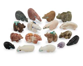 1425 Seventeen Zuni carved bear fetishes Mid/late 20th century, mostly Zuni Pueblo From artists including Abby Quam, comprising fourteen carved from various hardstones, two jet, and one shell; ten with inset turquoise, lapis, or coral heartlines, three mounted with offerings Each unsigned 17 pieces Largest height 2 3/8 in., width 3 1/4 in., depth 3/4 in.; Smallest height 1 1/8 in., width 1 1/4 in., depth 3/8 in. Estimate: $200 - $400