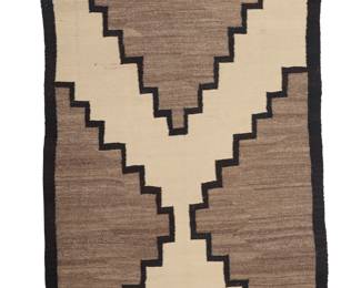 1227 A Diné (Navajo) regional rug First quarter 20th century Woven in grey, cream, and dark brown wool with a large central stepped X- form and floating elements to each end 7 ft. 6 in. x 3 ft. 10 in. approximately Estimate: $800 - $1,200