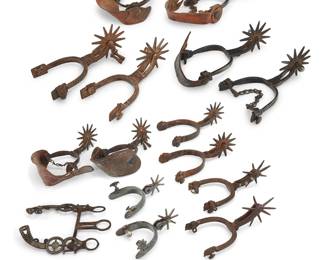 1203 A large group of Mexican spurs and a headstall Late 19th/20th century Seven pairs of Mexican spurs, each of various style of heel, shank, and rowel, most of wrought iron and with silver or mixed metal inlay, the smallest with chased silver accents, and two pairs with shaped leather straps, as well as an equestrian headstall with cased silver inlay in a stylized revolver motif 15 pieces Largest inner heel width 3 3/4 in., shank length 3 1/2 in., rowels diameter 4 in.; smallest inner heel width 3 in., shank length 1 1/2 in., rowels diameter 2 1/4 in. Estimate: $600 - $900