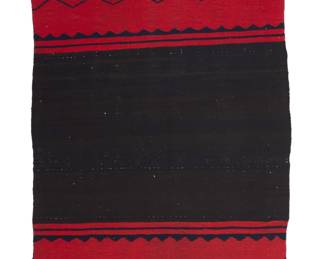 1206 A Diné (Navajo) Classic period half dress Third quarter 19th century A single panel worked in wide red bands to each end with contrast zigzags and scalloped narrow banding and fringed corners, woven in natural black, indigo-dyed blue, and red wool, the darker red dyed with lac and the lighter red (approximately 5% of all red yarns) dyed with 50% lac/50% cochineal 4 ft. 5 in. x 2 ft. 9 in. approximately Estimate: $2,000 - $3,000