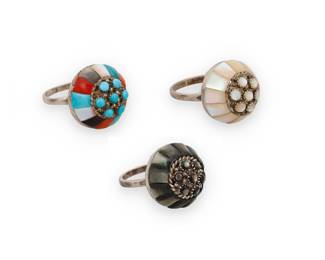 1360 Lee & Mary Weebothee (1927-2015 & 1934-1995, Zuni Pueblo) Three sterling silver domed rings, each cluster-set with cobblestone inlay, two in mother of pearl and one in grey shell, and one with multistone inlay including coral, turquoise, mother of pearl, and other shells Each stamped: Lee/Mary [script] / Zuni 3 pieces Ring sizes 7 1/4 to 6 1/2 18.8 grams gross Estimate: $300 - $500