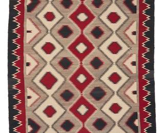 1282 A Diné (Navajo) regional rug Second half 20th century Woven in cream, red, grey, and black wool featuring multiple columns of alternating colored concentric serrated diamonds and with a complex sawtooth border to the long sides 5 ft. 11 in. x 3 ft. 10 in. approximately Estimate: $600 - $800