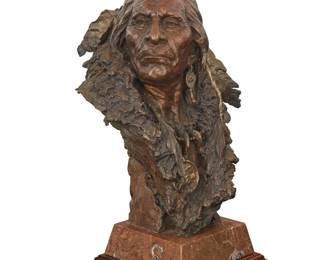 1106 John Coleman (b. 1949) "Black Moccasin," 2004 Patinated bronze on marble plinth on rotating wood base Edition: 32/35 Signed, dated, titled, numbered, and inscribed in the casting: HIDATSA CHEIF / JOHN COLEMAN / CA [conjoined] Height of bronze 18 in., width 12 1/4 in., depth 12 in.; height overall 21 5/8 in. Estimate: $7,000 - $10,000
