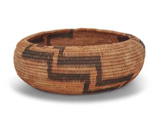 1164 A Pomo basketry bowl Attributed to Laura Fish Somersal (1892-1990, Pomo-Wappo), circa 1986 The large coiled low bowl with three radiating stepped zigzag motifs issuing from center to rim Height 3 in., diameter 9 in. (variable) Estimate: $500 - $700
