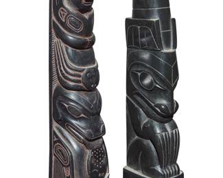 1138 Two carved model totem poles Mid-20th century; Pacific Northwest Comprising a Haida argillite carving with a single bear figure with narrow claws, and a Northwest Coast-style likely resin carving with multiple figures including a likely killer whale with a fish, and an octopus 2 pieces Larger height 5 1/4 in., width 1 in., depth 1 3/16 in.; smaller height 5 in., width 1 1/4 in., depth 1 1/8 in. Estimate: $300 - $500