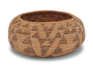 1165 A Pomo basketry bowl Mid-20th century; Northern California The small coiled low bowl with five columns of stacked zigzag triangle motifs Height 2 1/2 in., diameter 5 3/4 in. (variable) Estimate: $400 - $600