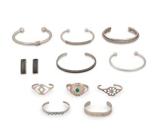 1395 Eleven Southwest-style sterling silver jewelry items Mid/late 20th century A large group comprising a three-wire cuff by Verna Tahe (Diné [Navajo]), a narrow ridged cuff with a pair of matching earrings, likely by Yazzie Johnson (Diné [Navajo]), and three further silver cuffs with wrapped wire accents and ball terminals, as well as five small child-sized cuffs in various styles including cast silver, a concho-style cuff with set malachite by George Kee (Diné [Navajo]), and two stampwork cuffs, one with row-set turquoise 12 pieces Variously stamped for artist: Y / L / GK / TAHE; seven stamped for Sterling Large cuffs 6 7/8 in. to 6 in. total inner C; child cuffs 5 in. to 4 1/4 in. total inner C; earrings 1 in. 150.2 grams gross Estimate: $300 - $500