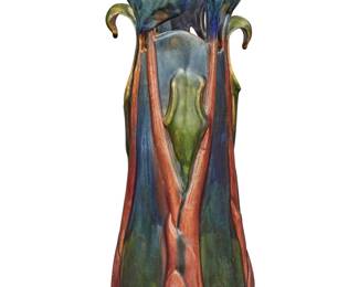1244 An American glazed earthenware vase Early 20th century, attributed to Tiffany Studios The polychrome glazed vase molded in the form of irises Unmarked Height 13 in., width 4 1/2 in., depth 4 1/2 in. Estimate: $1,500 - $2,000