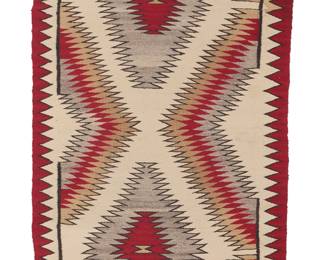 1271 A Diné (Navajo) regional rug Mid/late 20th century Woven in red, cream, tan, and grey wool with two central stacked concentric sawtooth diamonds and a sawtooth border to the long sides 4 ft. 9 1/2 in. x 2 ft. 5 1/2 in. Estimate: $500 - $700