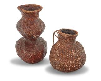 1174 Two Apache pitch-sealed basketry vessels Late 19th/early 20th century; Southeast United States Comprising two coiled jars including a tall double gourd-form jar and a smaller jar with two horsehair handles, each coated in pine pitch 2 pieces Larger height 13 1/2 in., width 7 1/2 in., depth 7 1/2 in.; smaller height 8 3/4 in., width 8 in., depth 8 in. irregular Estimate: $300 - $500
