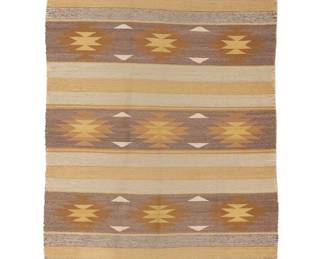 1289 A Diné (Navajo) Chinle/Wide Ruins rug Third quarter 20th century Woven in pale brown, ochre, yellow, cream, and grey wool in alternating serrated diamond and stripe banded motifs 4 ft. 1 in. x 2 ft. 10 in. approximately Estimate: $300 - $500
