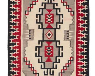 1283 A Diné (Navajo) regional rug Second half 20th century Woven in red, black, cream, and grey wool, with a central conjoined hooked stepped diamond, with feather elements and serrated elements to the ends, within a complex stepped hooked border 6 ft.11 in. x 4 ft. 3 in. Estimate: $700 - $900