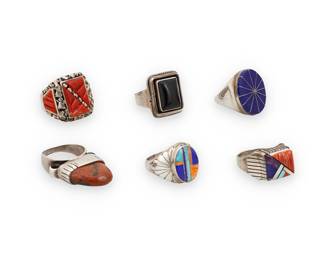 1411 Five large Southwest sterling silver and set stone rings Mid/late 20th century A group of chunky sterling silver rings, four with mosaic stone inlay including one by Ray Jack (Diné [Navajo]) with spiny oyster, coral, mother of pearl, and turquoise, one with lapis lazuli by likely Bobby Lujan (Taos Pueblo), and a large ring with elaborate sculptural coral inlay and nugget silver accents, as well as a ring with a set onyx cushion cabochon and a tall modernist style ring with set orange stone Four variously marked for artist: RA Jack / BL / E; one etched: by Chatt; two marked: Sterling 5 pieces Ring sizes 11 to 9 90.4 grams gross Estimate: $200 - $400