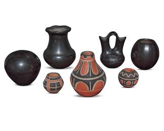 1076 Seven diminutive Pueblo pottery jars Second half 20th century Comprising:  Santa Clara Pueblo blackware:  Denny Gutierrez (1942-2013) A melon jar  Linda Askan (Jo'Povi [Cactus Flower]) (b. 1954) A wedding vase  Adrianna Naranjo (20th century) A seed jar  Greg Garcia (1961-2010) A vase with piecrust crimped rim  Santo Domingo Pueblo polychrome:  Hilda Coriz (1949-2007) A polychrome vase  Robert Tenorio (b. 1950) Two miniature polychrome jars All but one polychrome variously incised with artist's signature 7 pieces Height of tallest 4 3/4 in., diameter 3 5/8 in.; height of smallest 1 3/4 in., diameter 2 in. Estimate: $300 - $500