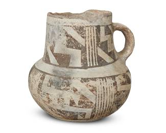 1026 An Anasazi black on white pottery cup 7th-14th century CE With lug handle, painted with black bands of geometric motifs on white slip ground Height 5 3/8 in., width 5 5/8 in., depth 5 3/8 in. Estimate: $200 - $400