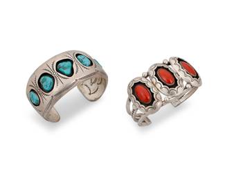 1375 Two Diné (Navajo) sterling silver shadowbox cuff bracelets Mid/late 20th century Comprising a chunky cuff set with five graduated turquoise and with elaborate stamp work to the interior and exterior, as well as a four-wire cuff set with three oval coral cabochons within stamped scalloped surrounds The first stamped: C.O. Lee / 919 The first 6 3/8 in. total inner C x 1 1/2 in., including a 1 1/8 in. gap; the second 6 3/8 in. total inner C x 1 1/2 in., including a 1 in. gap 120.7 grams gross Estimate: $800 - $1,200