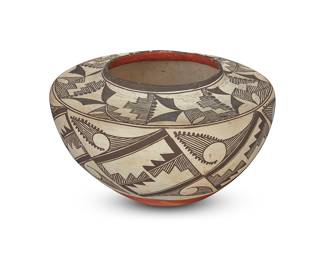 1047 An Acoma Pueblo polychrome pottery jar First half 20th century With black fine-line and geometric motifs on white slip ground above a terracotta wash and puki indentation Height 5 3/4 in., diameter 9 1/2 in. Estimate: $1,000 - $1,500