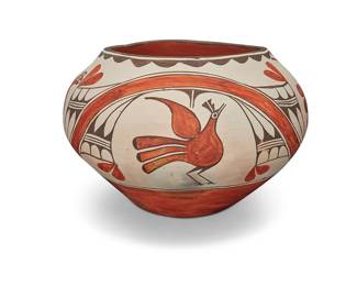 1063 Seferina Bell (1920-1986, Zia Pueblo) A large polychrome globular jar With four bird motifs including parrots, amidst curvilinear and abstract plant or feather motifs, with scalloped rim edging and a red base Signed to slip to lower side: [bell motif for artist] / Zia Pueblo Height 10 1/4 in., diameter 16 1/2 in. Estimate: $1,200 - $1,800