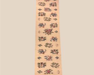 Light runner with delicate repeating floral motifs and subtle border.