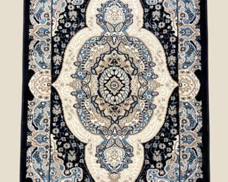 Navy and ivory rug with an elaborate central medallion and dramatic traditional design.