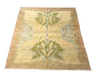 Warm gold rug with softly distressed botanical patterning and muted accents.